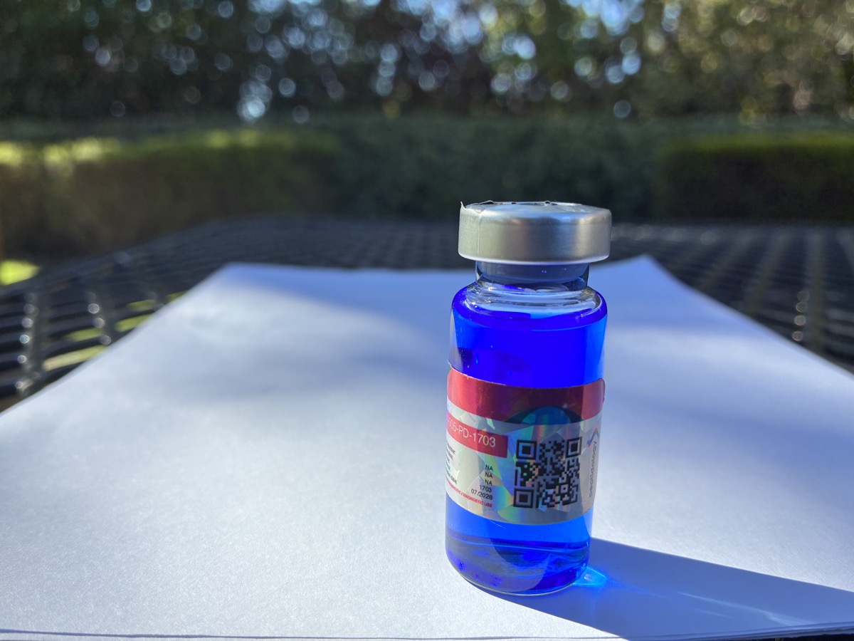 A reconstituted vial of the blend, blue from the GHK-Cu copper.